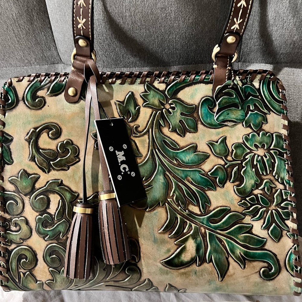 What a Wonderful Tan and Green Leather Embossed M.C. Satchel